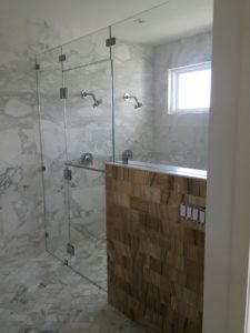 marble shower with large glass enclosure