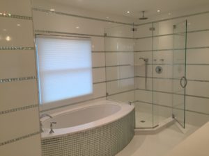 large bathroom with low iron glass enclosure